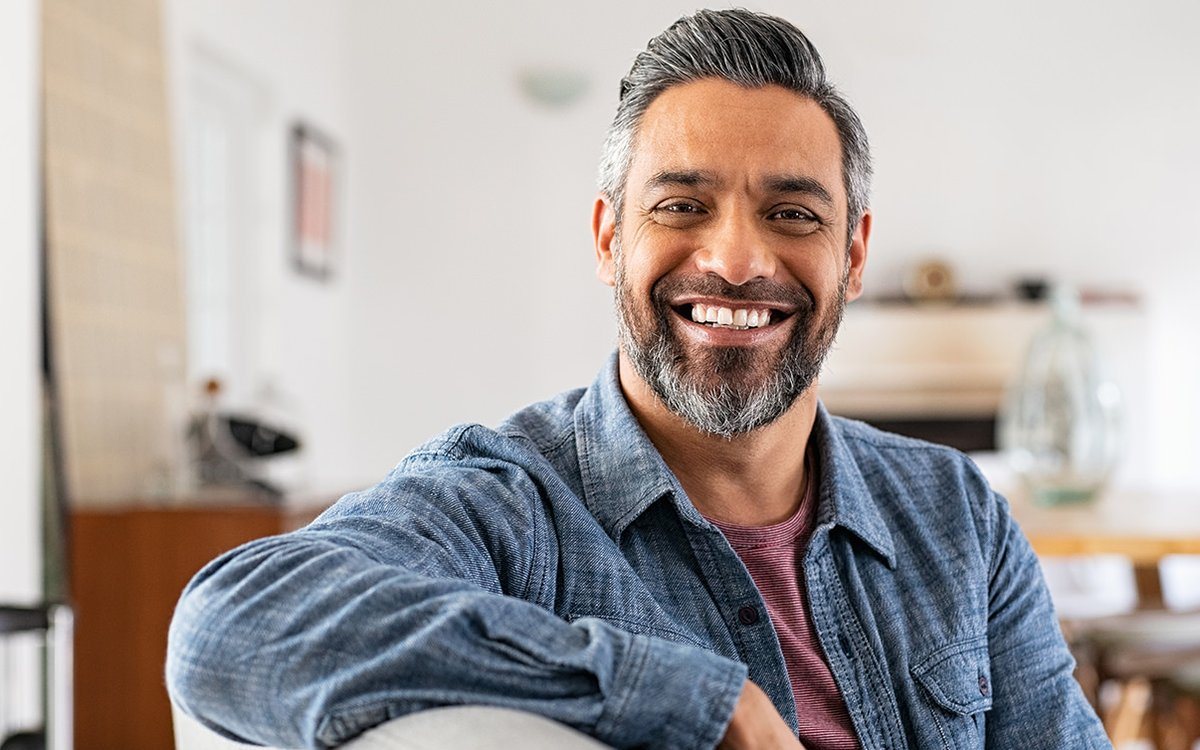 Smiling man in his 40s at home